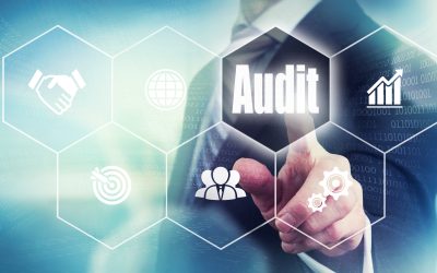Businessman pressing an Audit concept button.